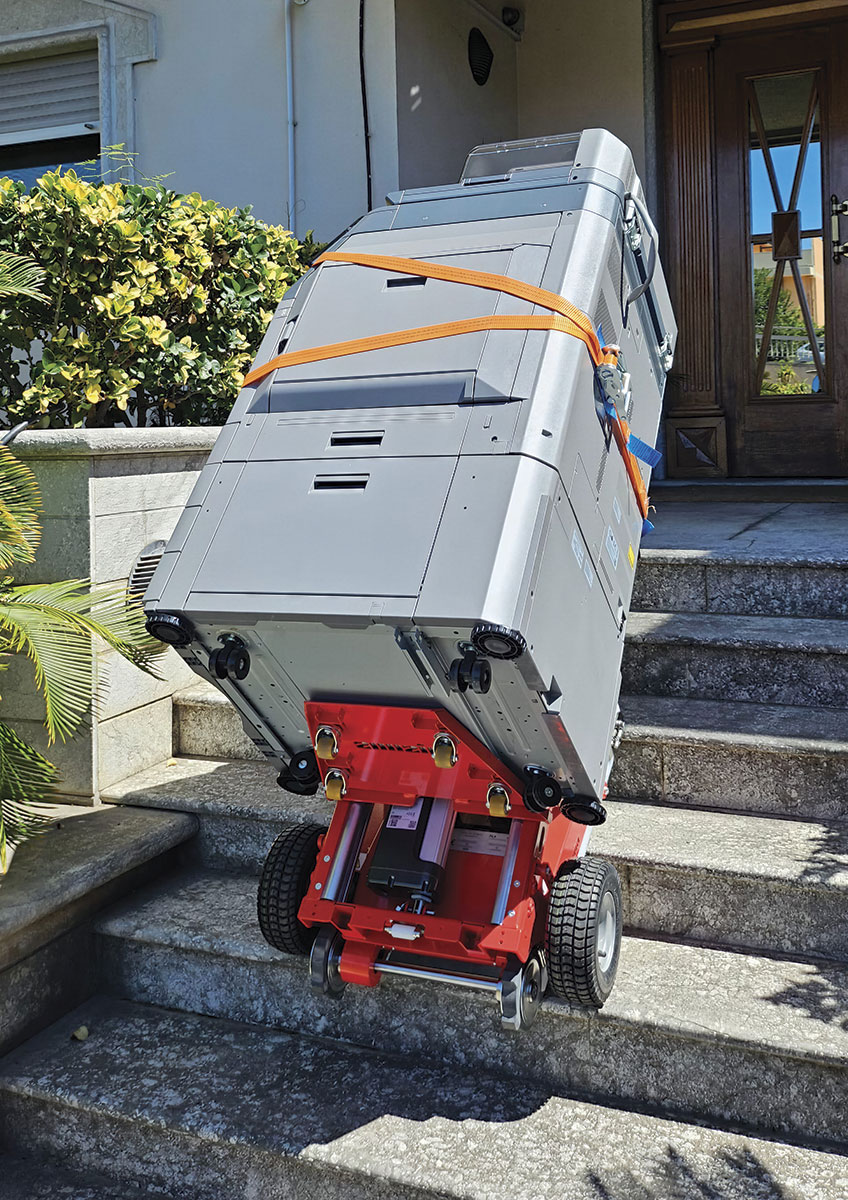 Buddy stair climber transporting photocopier on internal office stairs