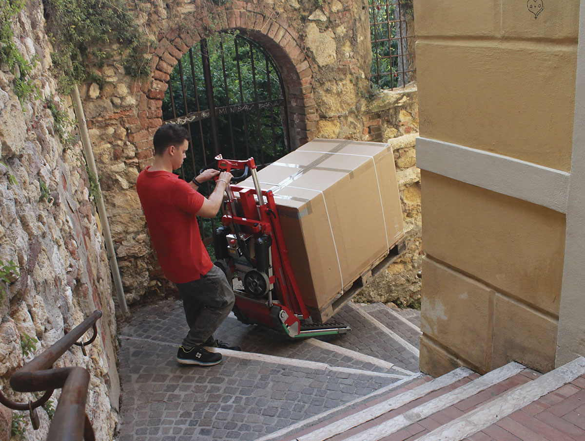 Stair-climbing pallet truck Domino PT on winder staircase with alternating treads