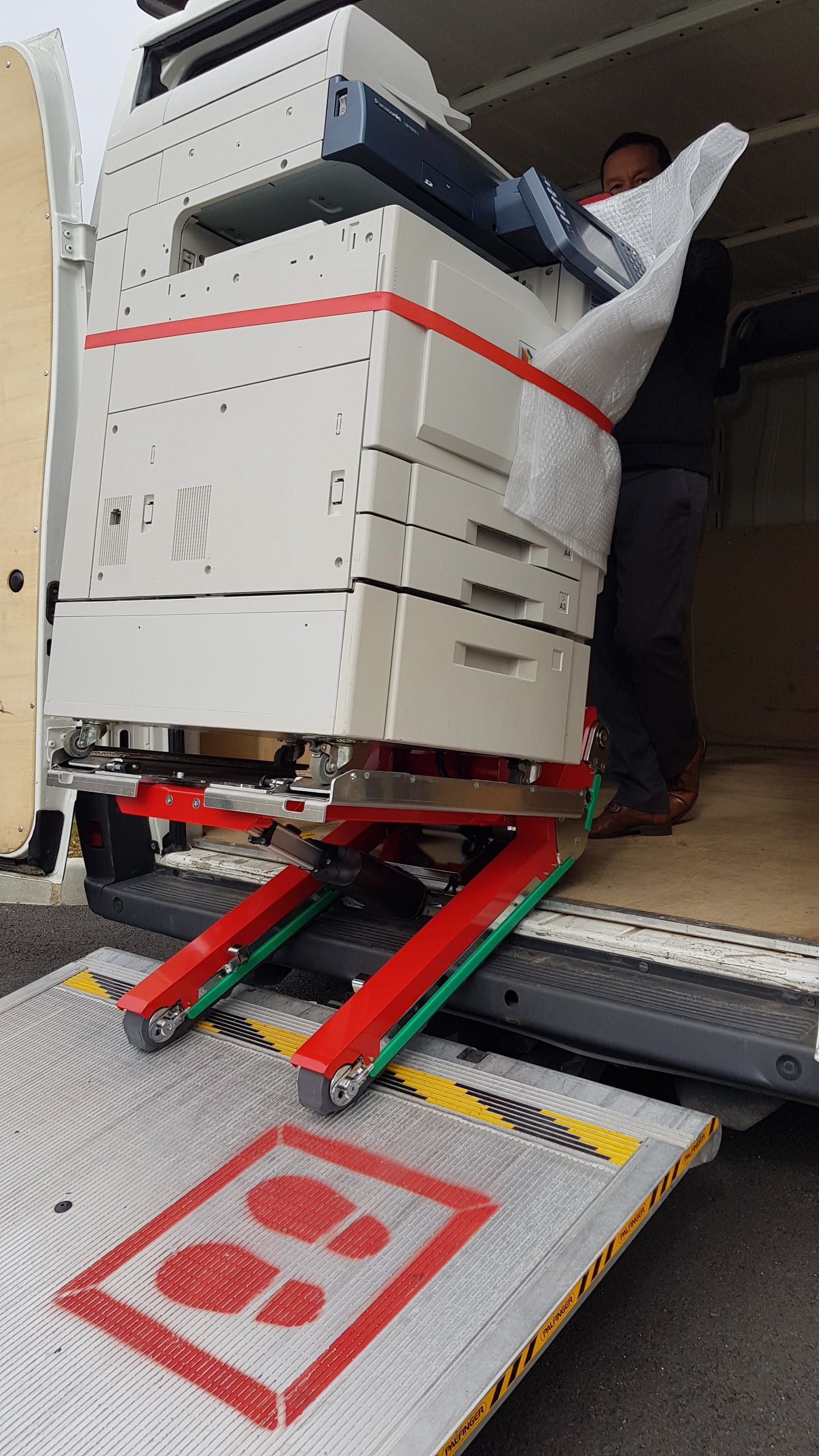 Photocopier transport on van ramp with stair climber